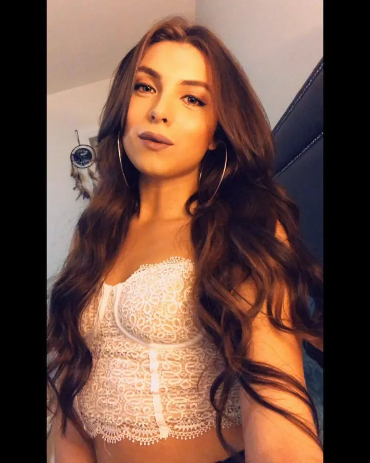Femme en top blanc en dentelle, selfie dans une chambre